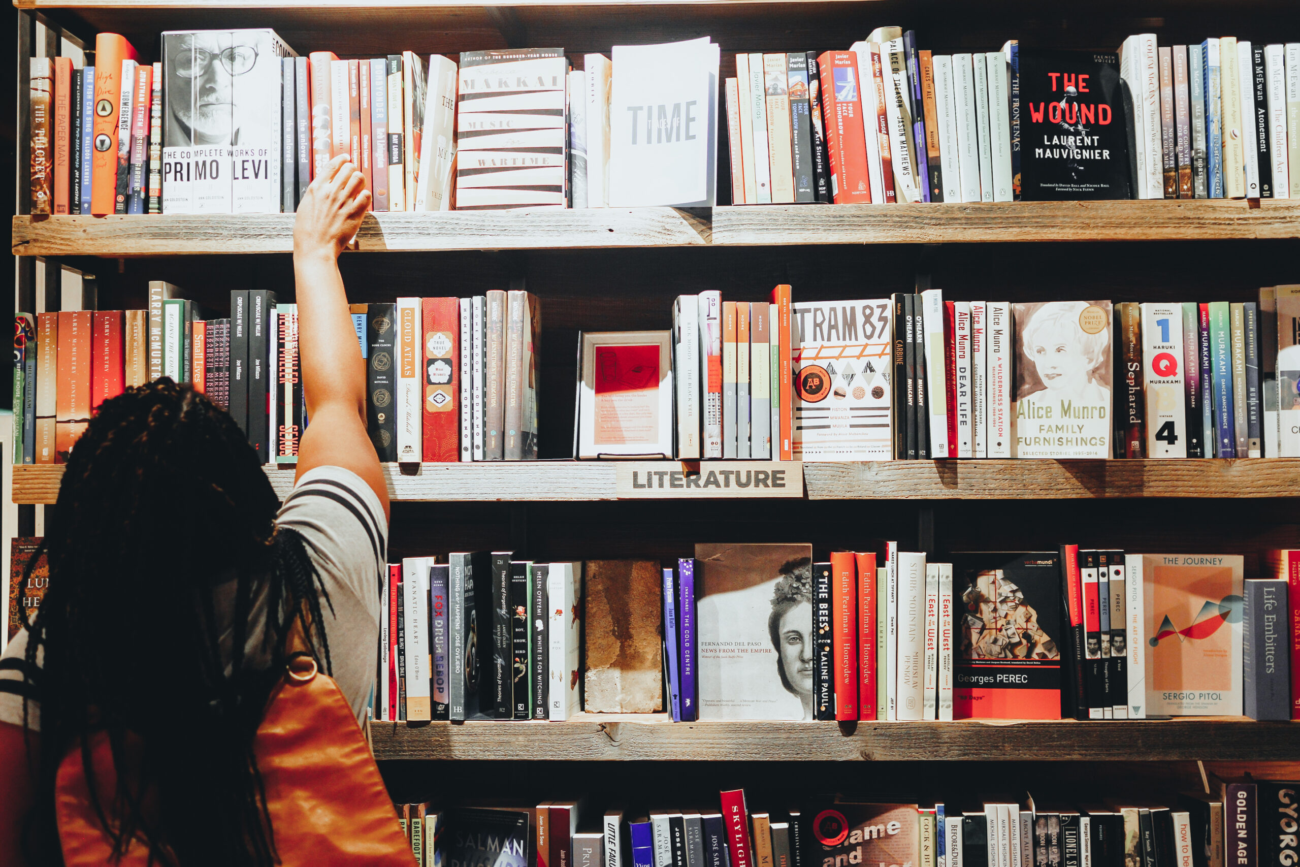Girl reaching for book - Black Love 7 Black Women Authors Crushing the Young Adult Novel Scene in 2019