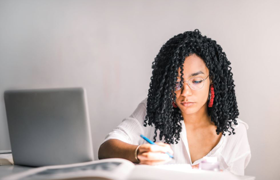 Woman writing - Black Love A Complete Guide to Understanding Your 2020 Taxes