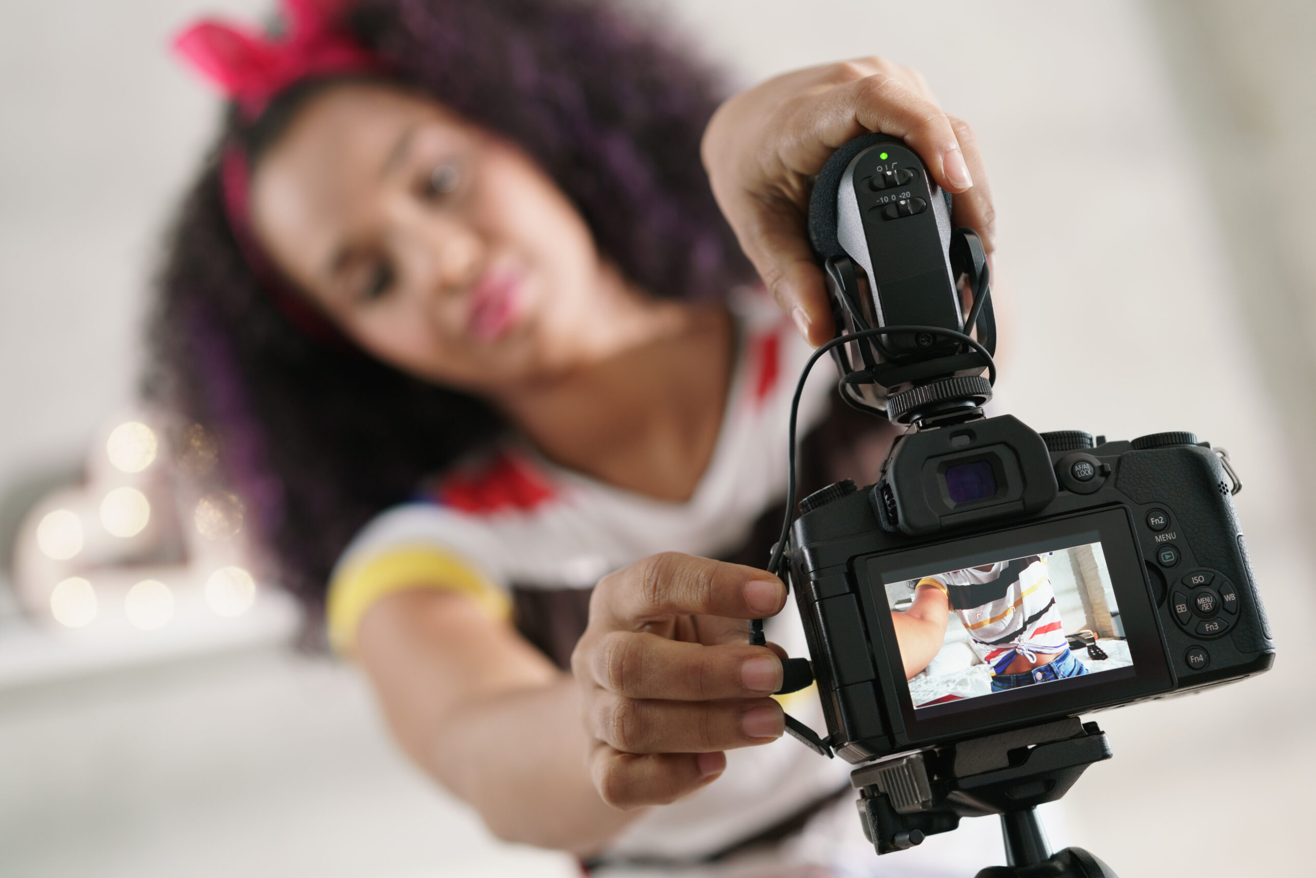 Woman setting up camera (Photo courtesy of Shutterstock.com) - Black Love Woman setting up camera (Photo courtesy of Shutterstock.com)