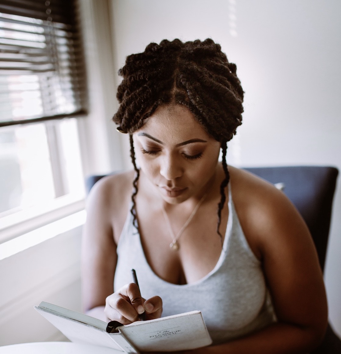 Woman writing (Photo courtesy of Ayana Iman)