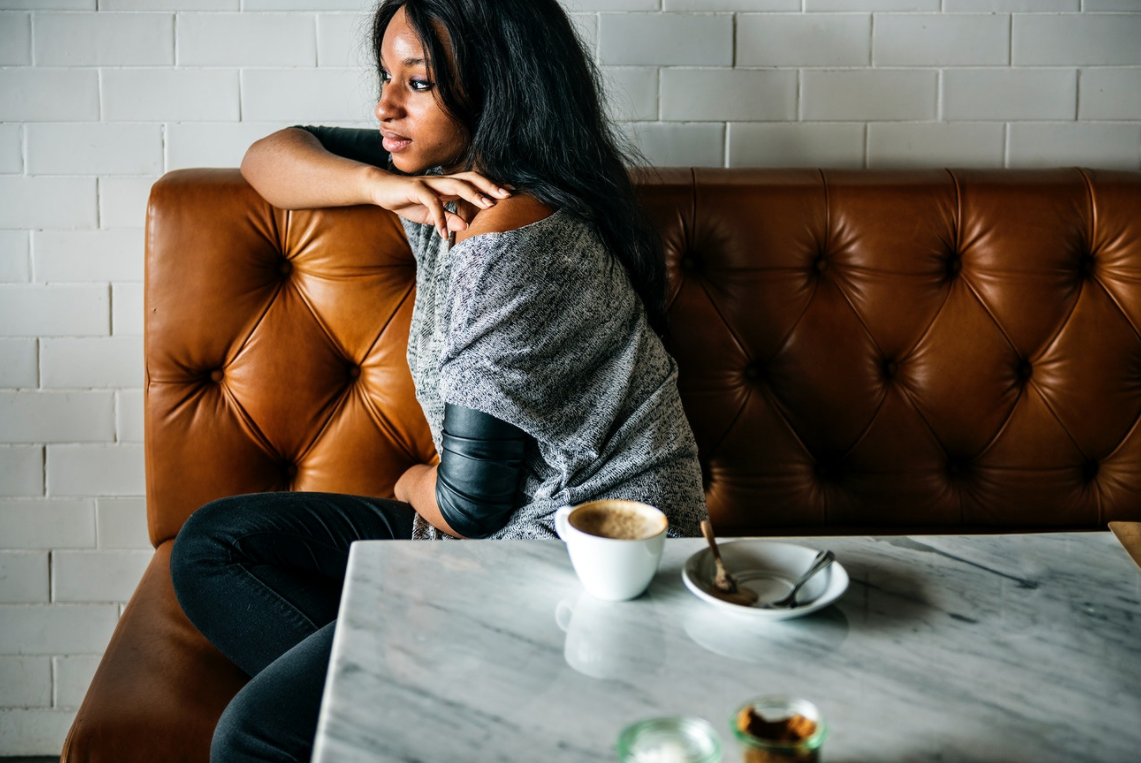 Woman sitting in restaurant (Photo courtesy of rawpixel.com)