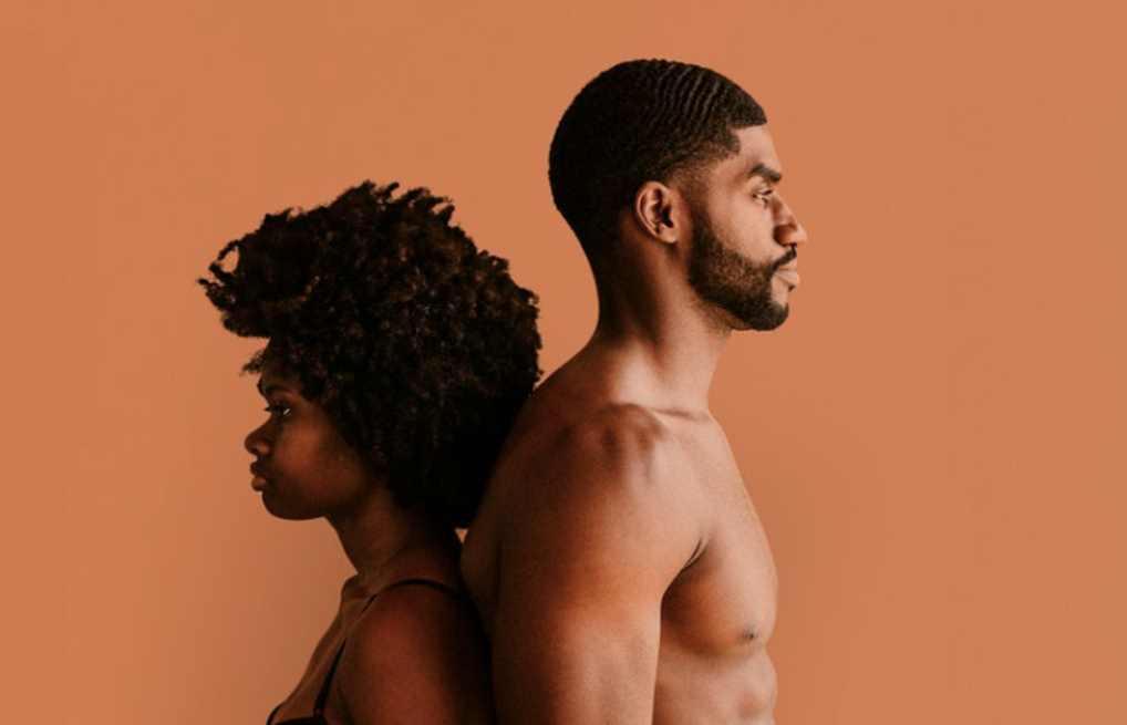 Man and woman standing back to back (Courtesy of rawpixel.com)