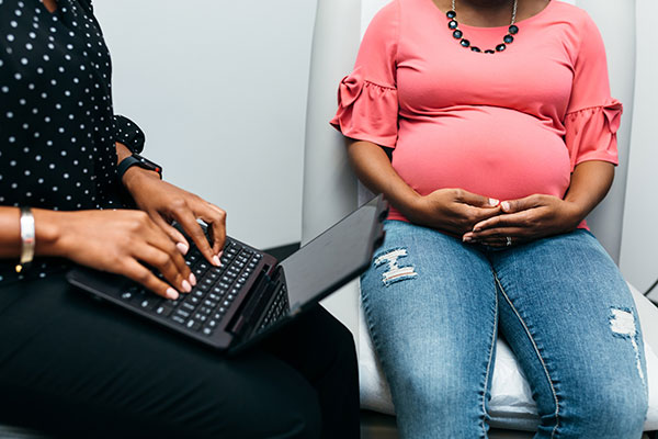 Credit: commonwealthfund.org - Black Love Pregnant woman with doctor (Credit: commonwealthfund.org)
