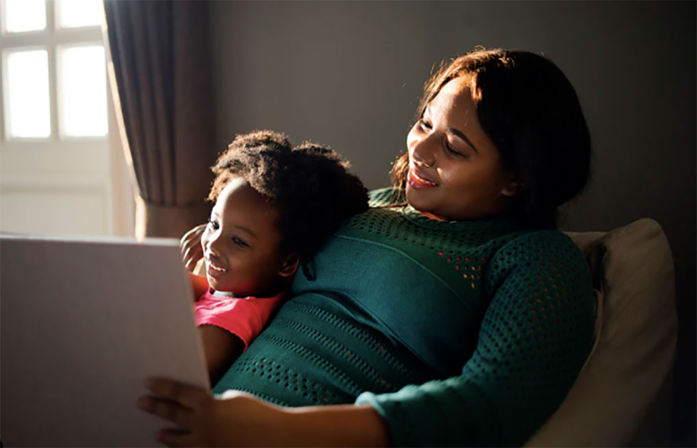 Mom with her daughter on laptop