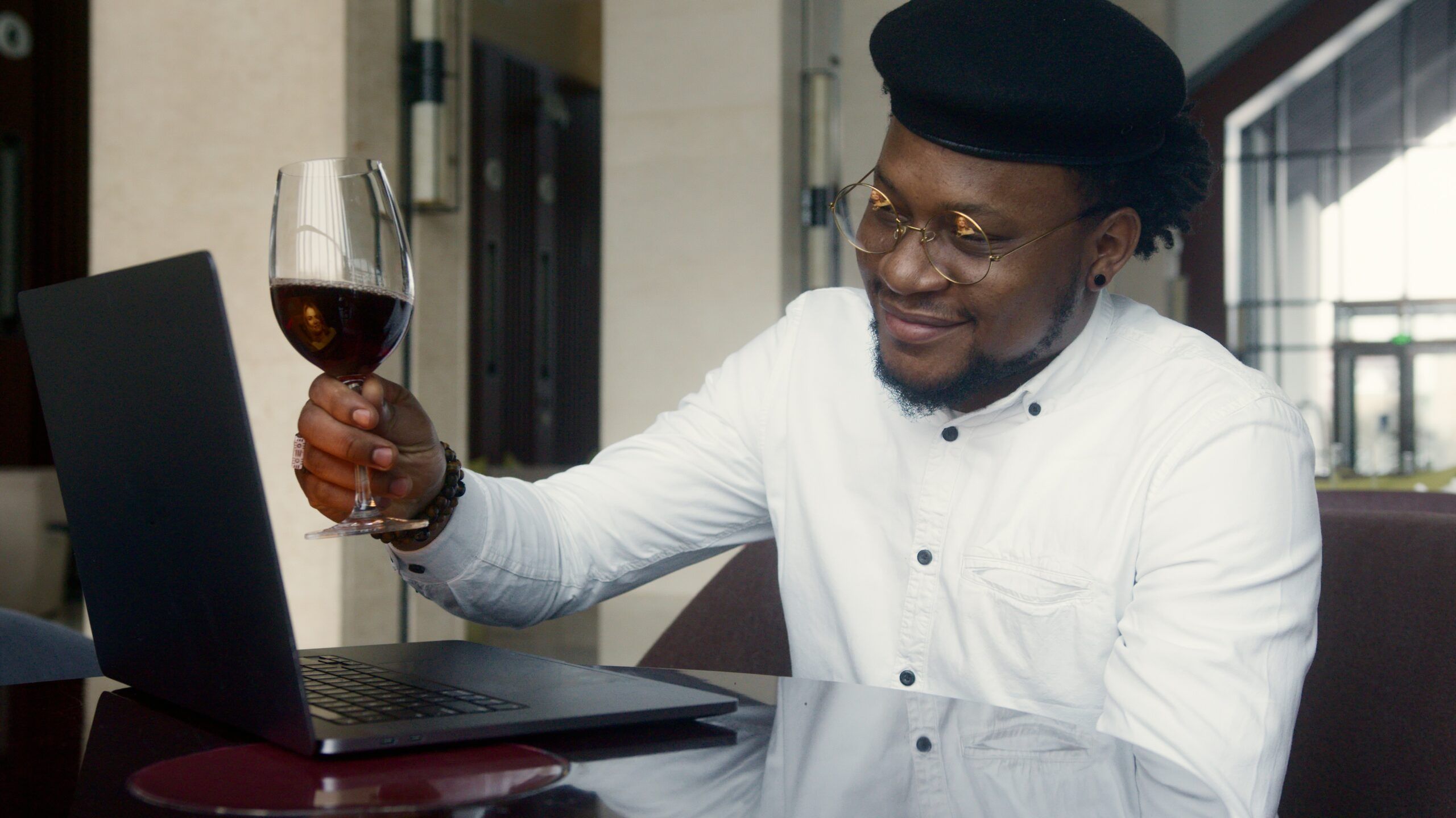 Courtesy of pexels.com - Black Love Man with wine on a laptop call