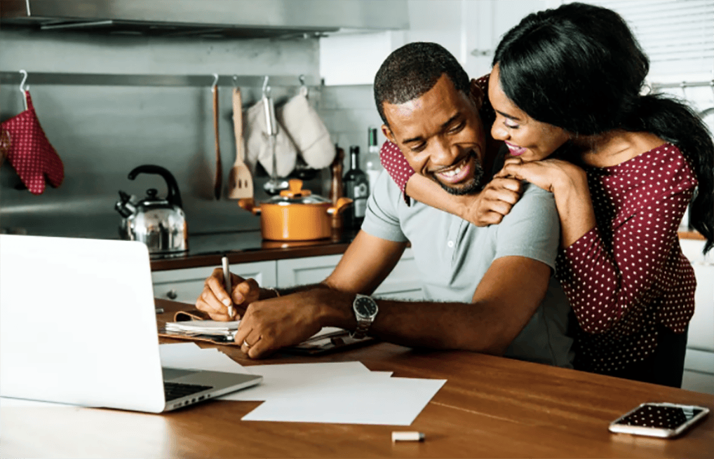 Courtesy of rawpixel.com - Black Love Couple at kitchen table with laptop