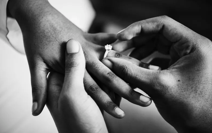 Courtesy of rawpixel.com - Black Love Man putting on ring on woman's finger