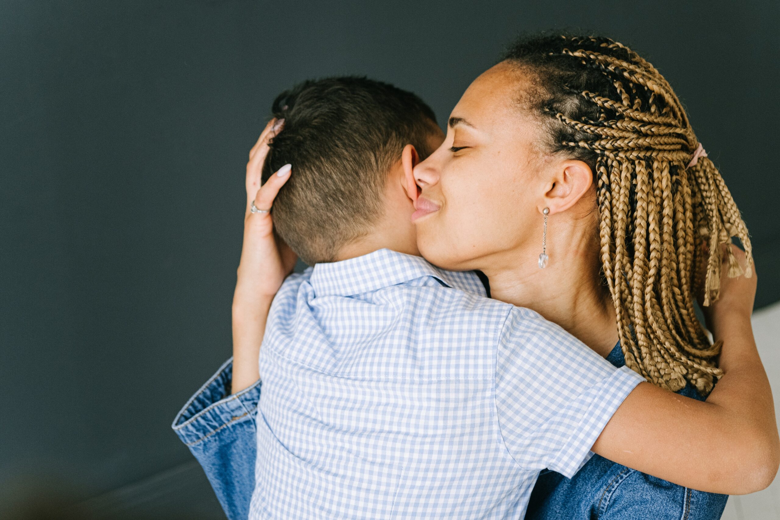 Courtesy of pexels.com - Black Love Mom hugging her son