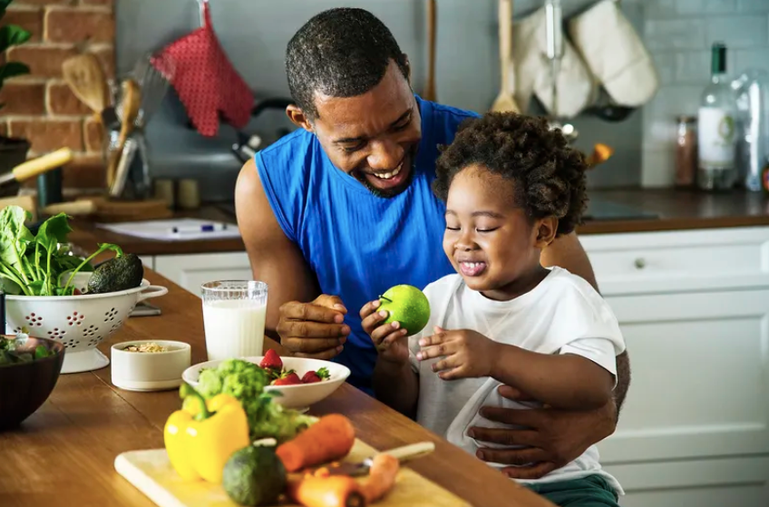 father eating healthy food with son