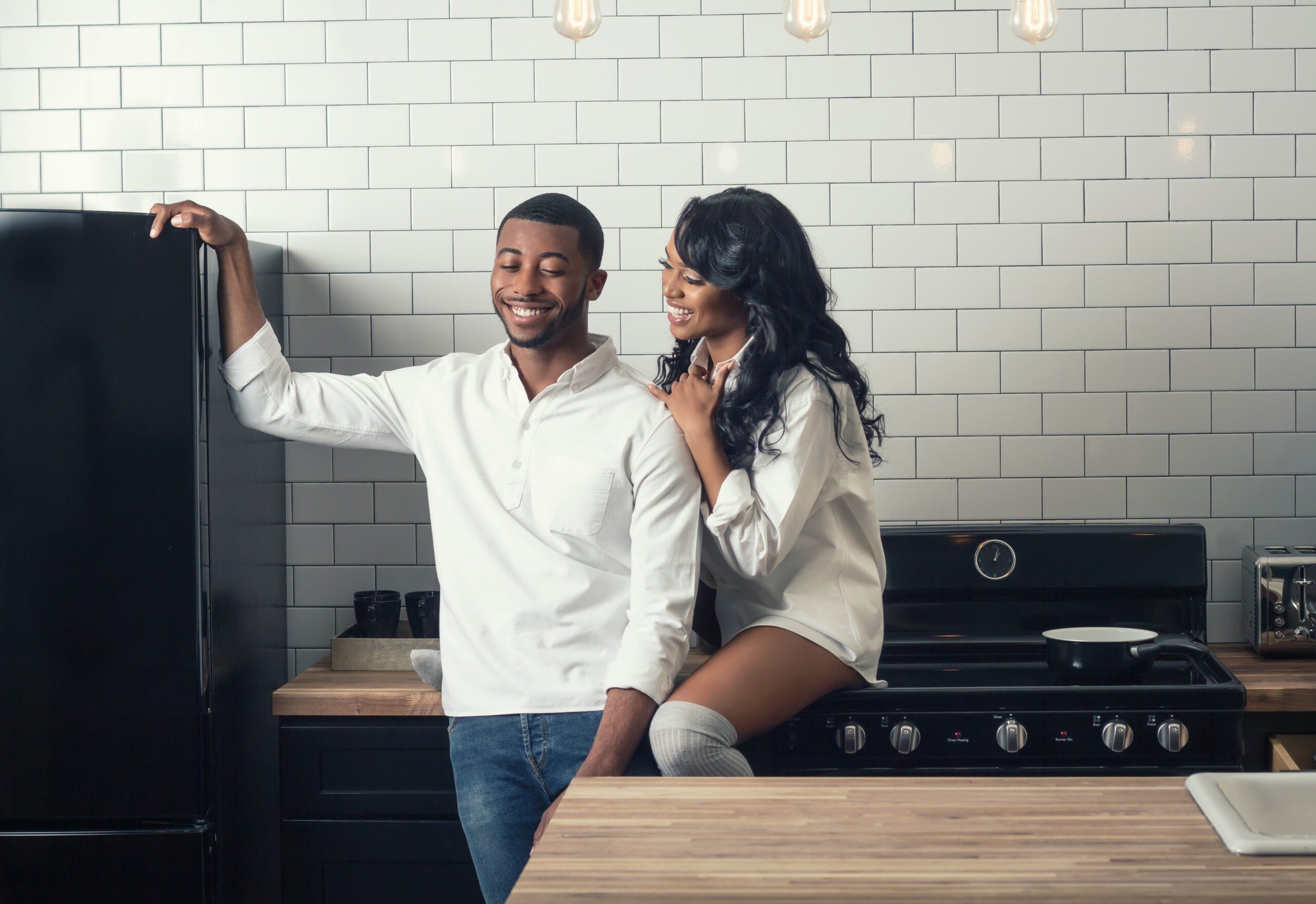 Courtesy of unsplash.com (couple smiling in the kitchen) - Black Love