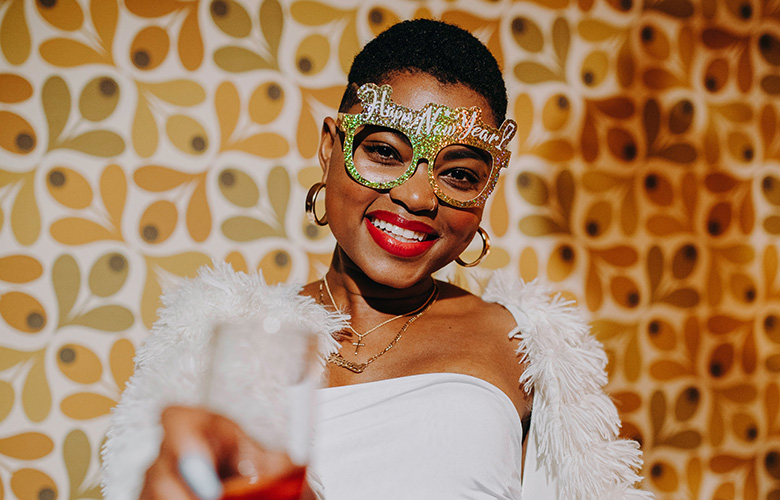 woman smiling while celebrating the new year