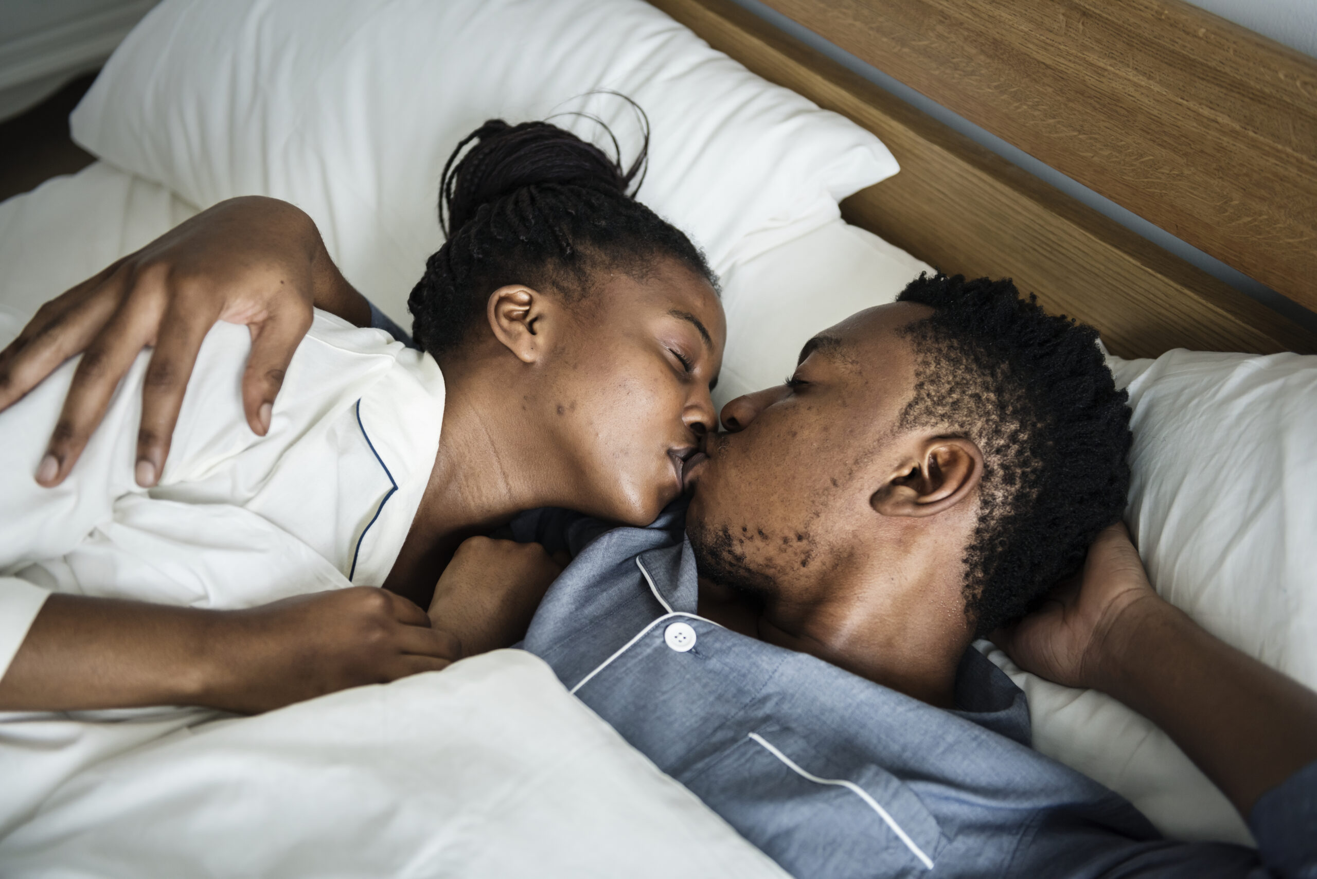 A couple kissing in bed (Courtesy of rawpixel.com) - Black Love